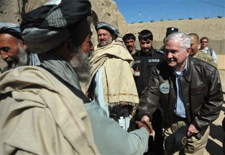 US Defense Secretary Robert Gates, right, greets village elders before meeting with the village council during a visit to Combat Outpost Kowall, Afghanistan, on Tuesday. Gates hailed progress in the key battleground of southern Afghanistan Tuesday, meeting troops before the planned start of foreign force withdrawals from July.